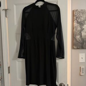 Black dress with mesh sleeves and body cutouts on stomach and back sides